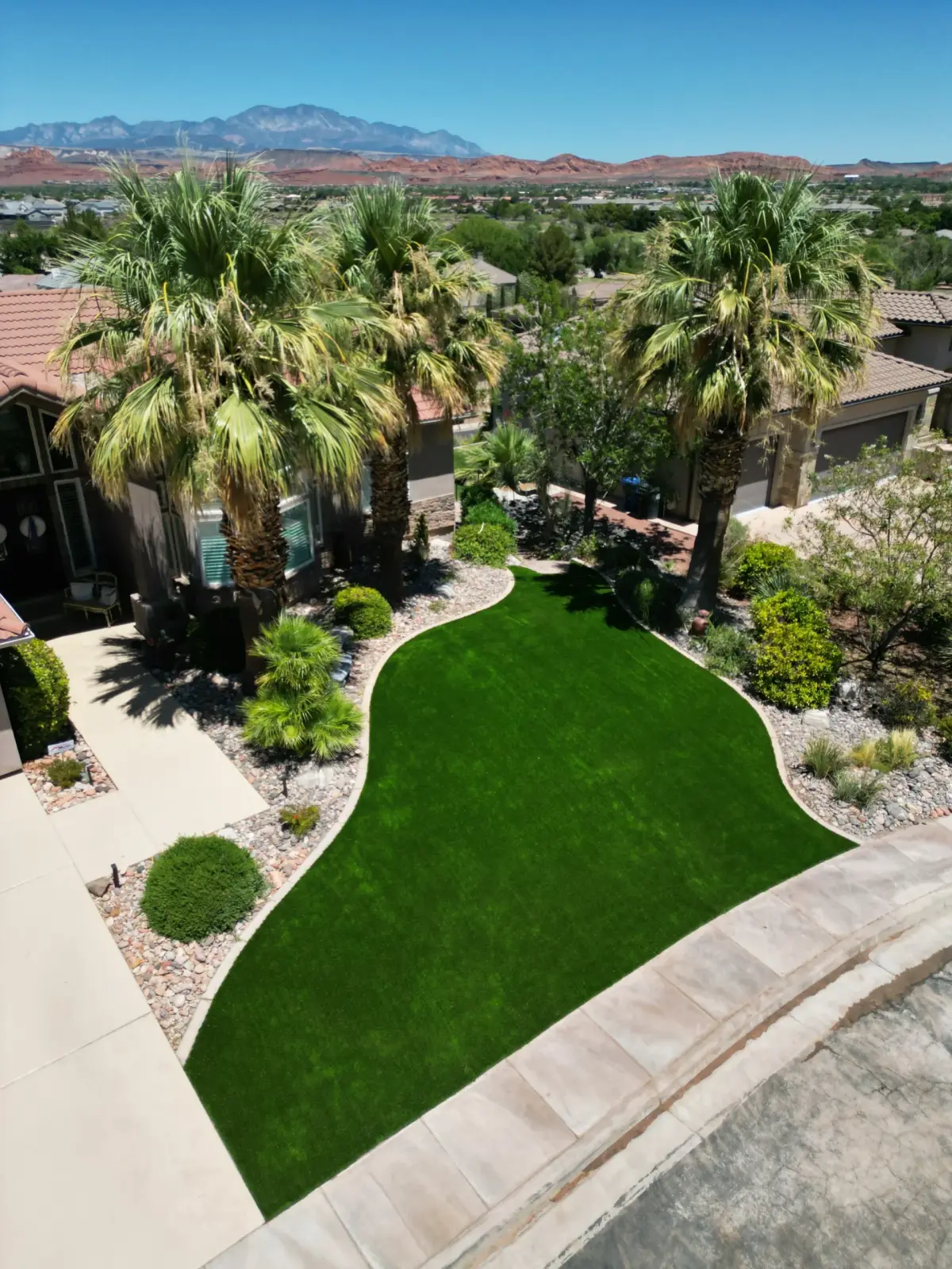 Aerial view of a curved turf lawn with palms