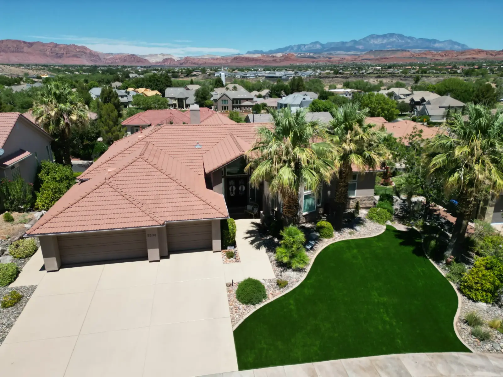 Aerial view of a St. George home with palm trees and new turf