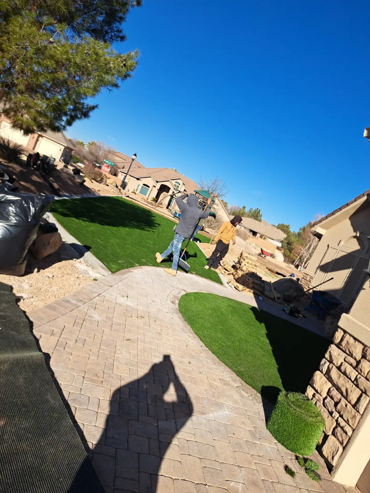 Hillside yard with turf and pavers
