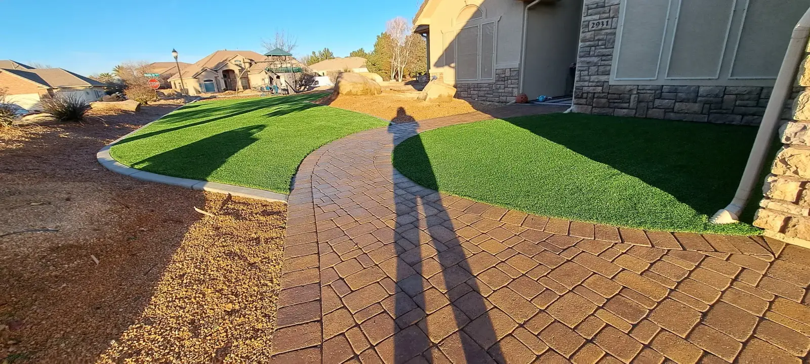 Turf beside a curved paver walkway